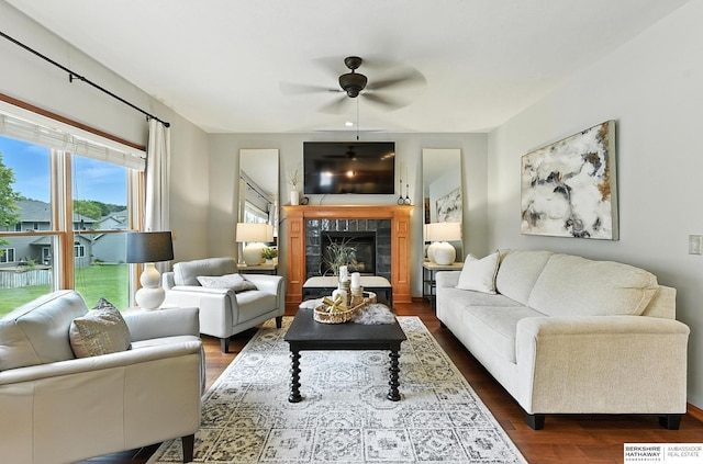 17534 Jefferson St, Omaha, NE 68135 - living area featuring dark wood finished floors, a ceiling fan, and a fireplace