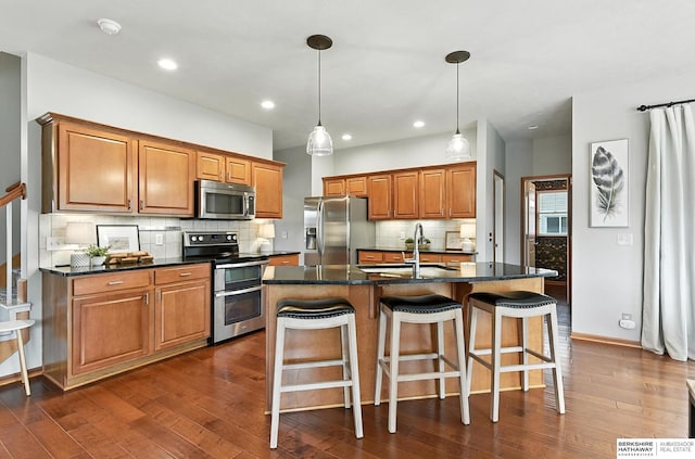 17534 Jefferson St, Omaha, NE 68135 - kitchen featuring appliances with stainless steel finishes, brown cabinetry, dark wood-type flooring, decorative backsplash, and recessed lighting