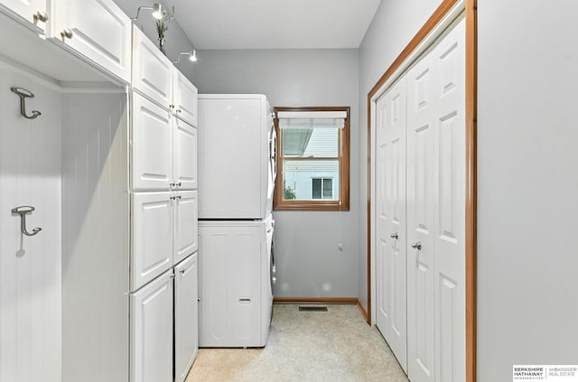 17534 Jefferson St, Omaha, NE 68135 - laundry area featuring cabinet space and stacked washing machine and dryer