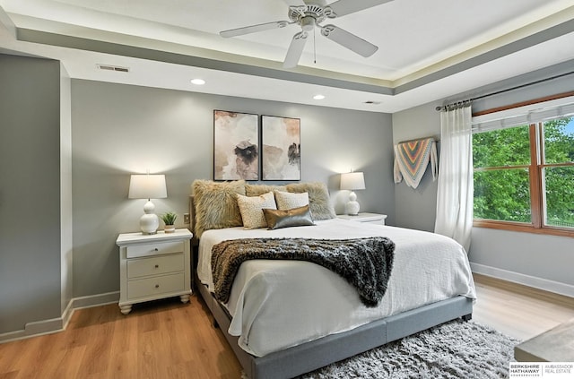 17534 Jefferson St, Omaha, NE 68135 - bedroom featuring light wood finished floors, a raised ceiling, recessed lighting, and a ceiling fan