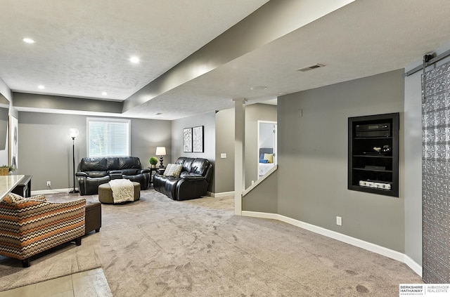17534 Jefferson St, Omaha, NE 68135 - carpeted living room with a barn door, a textured ceiling, and recessed lighting