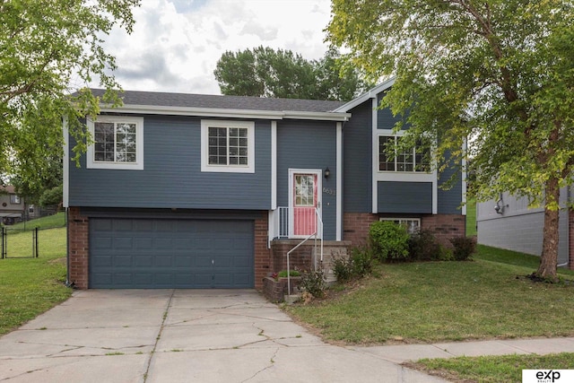 6633 N 115th St, Omaha, NE 68164 - bi-level home featuring an attached garage, concrete driveway, and brick siding