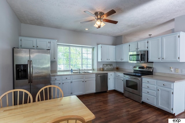 6633 N 115th St, Omaha, NE 68164 - kitchen with stainless steel appliances, ceiling fan, a textured ceiling, light countertops, and dark wood-type flooring