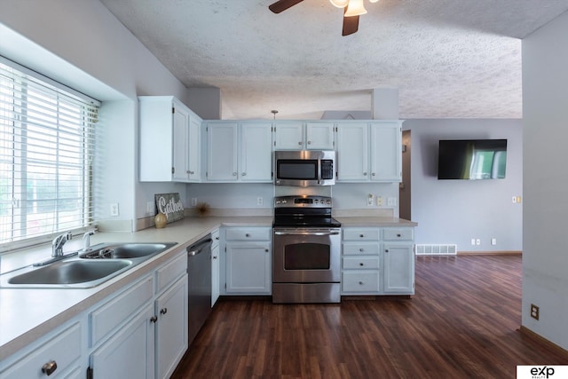 6633 N 115th St, Omaha, NE 68164 - kitchen with stainless steel appliances, dark wood-style floors, light countertops, a ceiling fan, and a textured ceiling
