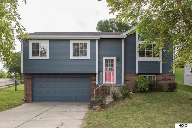 6633 N 115th St, Omaha, NE 68164 - raised ranch featuring brick siding, driveway, and a garage
