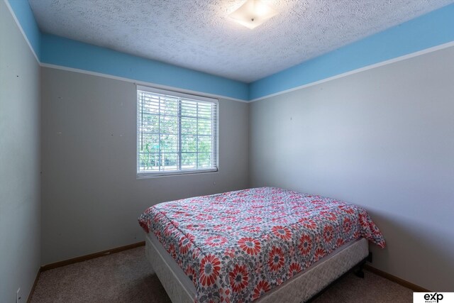 6633 N 115th St, Omaha, NE 68164 - carpeted bedroom featuring a textured ceiling and baseboards