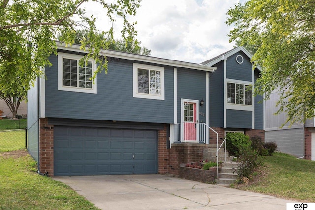 6633 N 115th St, Omaha, NE 68164 - raised ranch with a garage, concrete driveway, and brick siding