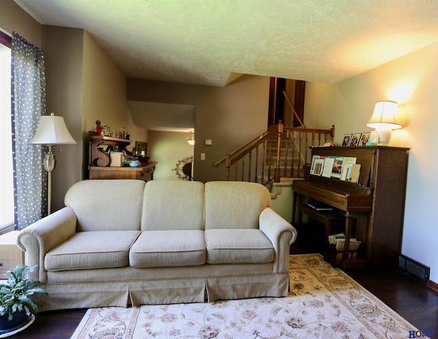 1365 N Chestnut St, Wahoo, NE 68066 - living room with wood finished floors, stairs, and a textured ceiling