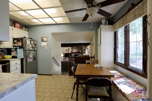 1365 N Chestnut St, Wahoo, NE 68066 - kitchen featuring light countertops, range, white cabinets, freestanding refrigerator, and a ceiling fan
