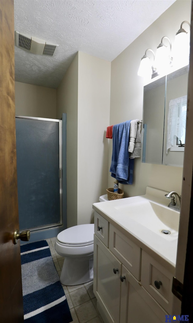 1365 N Chestnut St, Wahoo, NE 68066 - bathroom with a shower stall, vanity, tile patterned flooring, and a textured ceiling