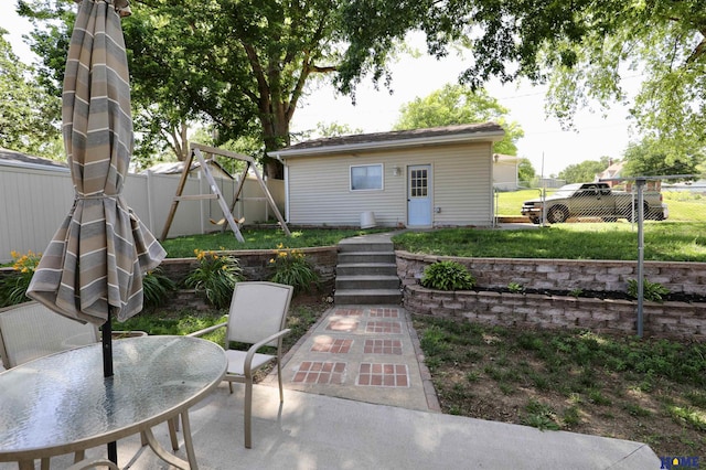 1365 N Chestnut St, Wahoo, NE 68066 - back of property featuring a patio area, a fenced backyard, outdoor dining space, and an outdoor structure