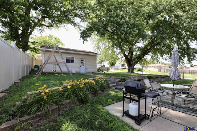 1365 N Chestnut St, Wahoo, NE 68066 - fenced backyard with outdoor dining space, a patio area, and a playground