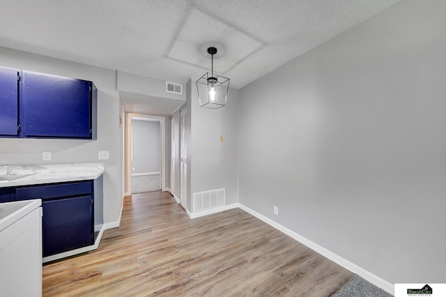 1207 B St, Lincoln, NE 68502 - unfurnished dining area featuring light wood finished floors and a textured ceiling