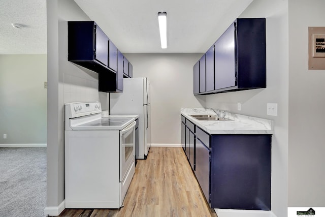 1207 B St, Lincoln, NE 68502 - kitchen featuring white appliances, light countertops, blue cabinets, and light wood-style floors