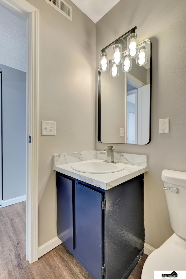 1207 B St, Lincoln, NE 68502 - half bathroom featuring vanity and wood finished floors