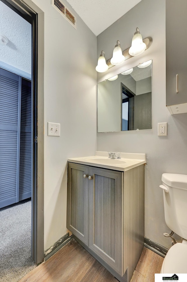 1207 B St, Lincoln, NE 68502 - half bathroom with vanity and wood finished floors