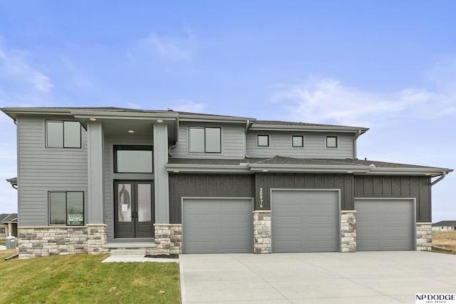 20976 Ogden St, Elkhorn, NE 68022 - prairie-style home featuring stone siding, driveway, an attached garage, and board and batten siding