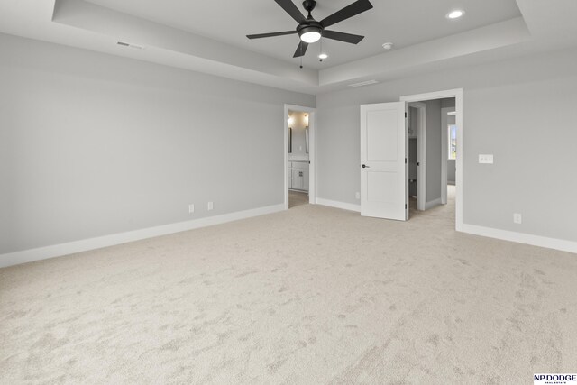 20976 Ogden St, Elkhorn, NE 68022 - unfurnished bedroom with a tray ceiling, light colored carpet, recessed lighting, and connected bathroom