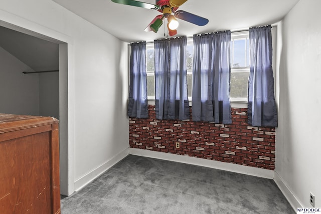 1107 E 1st St, Fremont, NE 68025 - unfurnished bedroom with multiple windows, carpet floors, and a ceiling fan