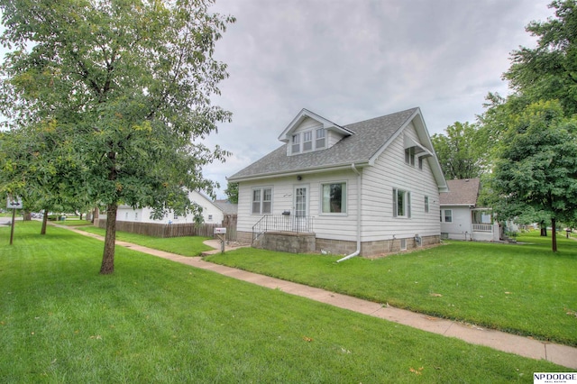 1107 E 1st St, Fremont, NE 68025 - view of front of house with a front lawn and a shingled roof