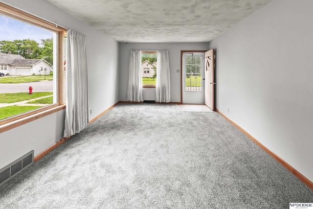 1107 E 1st St, Fremont, NE 68025 - unfurnished room featuring carpet flooring and a textured ceiling