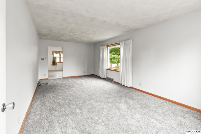 1107 E 1st St, Fremont, NE 68025 - carpeted empty room featuring baseboards and a textured ceiling