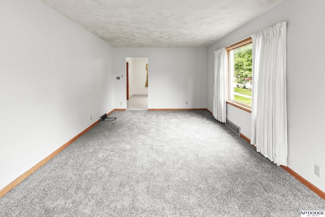 1107 E 1st St, Fremont, NE 68025 - spare room featuring carpet flooring and a textured ceiling