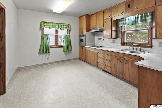 1107 E 1st St, Fremont, NE 68025 - kitchen featuring under cabinet range hood, brown cabinetry, stainless steel oven, light countertops, and black electric cooktop