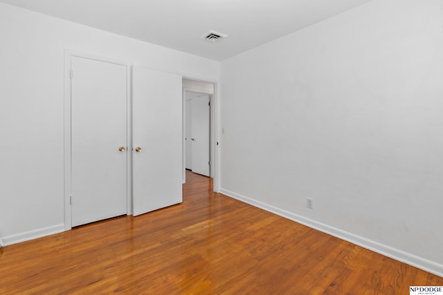 7922 Himebaugh Ave, Omaha, NE 68134 - unfurnished bedroom with wood finished floors and baseboards
