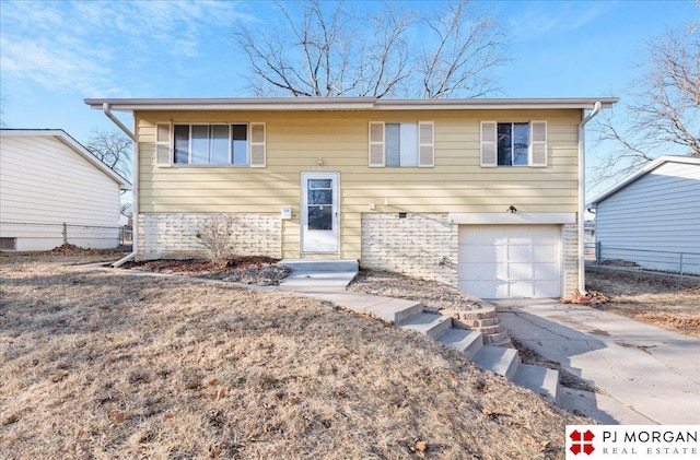 14030 Orchard Ave, Omaha, NE 68137 - bi-level home featuring driveway and an attached garage