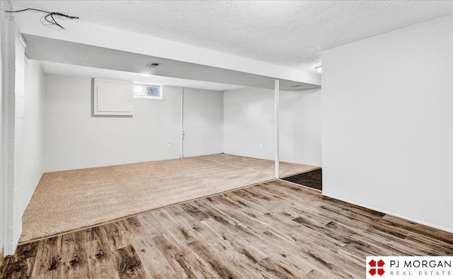 14030 Orchard Ave, Omaha, NE 68137 - basement featuring wood finished floors and a textured ceiling