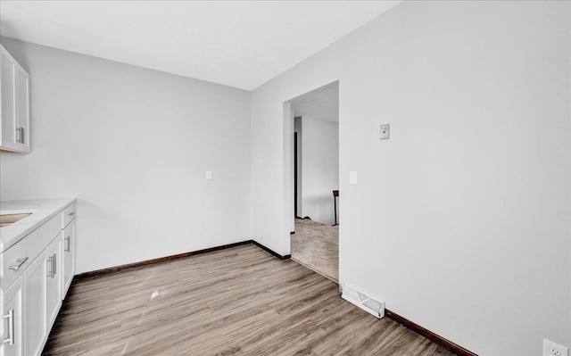 14030 Orchard Ave, Omaha, NE 68137 - kitchen featuring light wood-style flooring, white cabinetry, and light countertops