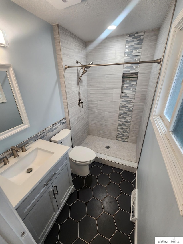 5020 N 106th St, Omaha, NE 68134 - full bathroom with tile patterned floors, a stall shower, vanity, and a textured ceiling