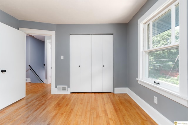 3207 Castelar St, Omaha, NE 68105 - unfurnished bedroom featuring light wood-style floors and a closet