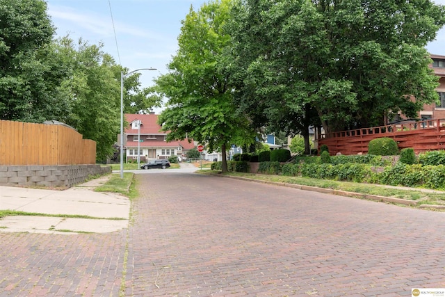 3207 Castelar St, Omaha, NE 68105 - view of decorative road featuring traffic signs, street lighting, and curbs