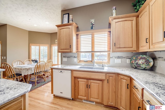 223 N Lakeview Way, Ashland, NE 68003 - kitchen featuring white dishwasher, light brown cabinets, tasteful backsplash, light wood-type flooring, and a textured ceiling