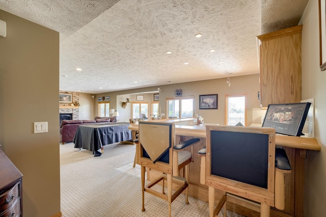 223 N Lakeview Way, Ashland, NE 68003 - dining area featuring light carpet, recessed lighting, a textured ceiling, and a fireplace