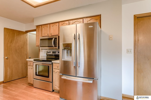 5001 W Sparrow Ln, Lincoln, NE 68528 - kitchen with appliances with stainless steel finishes, light wood-style floors, light countertops, and light brown cabinets