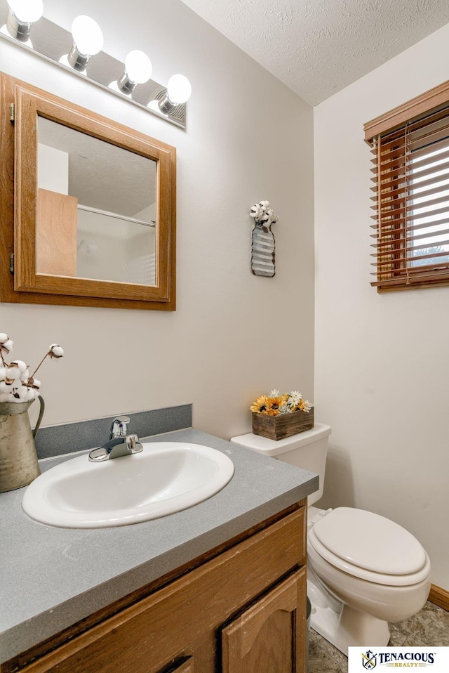 5001 W Sparrow Ln, Lincoln, NE 68528 - bathroom featuring vanity and a textured ceiling