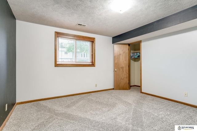 5001 W Sparrow Ln, Lincoln, NE 68528 - carpeted spare room featuring a textured ceiling and baseboards