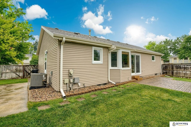 5001 W Sparrow Ln, Lincoln, NE 68528 - back of property featuring a fenced backyard, a patio area, and roof with shingles