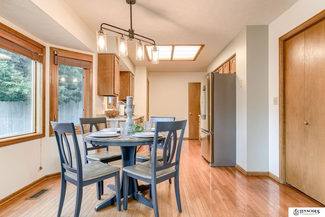 5001 W Sparrow Ln, Lincoln, NE 68528 - dining room featuring light wood finished floors and baseboards