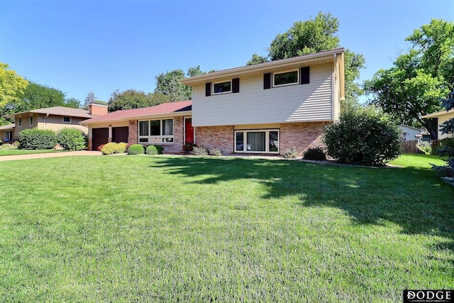 2204 Bramblewood Ln, Fremont, NE 68025 - split level home with an attached garage, a front yard, and brick siding