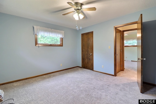 2204 Bramblewood Ln, Fremont, NE 68025 - unfurnished bedroom featuring light carpet, ceiling fan, and a closet