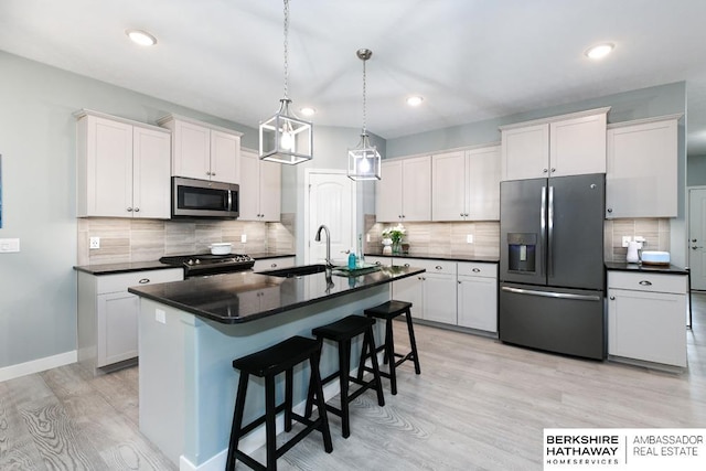 10818 S 109th St, Papillion, NE 68046 - kitchen with stainless steel appliances, dark countertops, light wood-type flooring, backsplash, and a breakfast bar