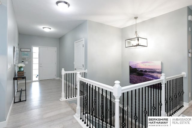 10818 S 109th St, Papillion, NE 68046 - hallway featuring an upstairs landing, wood finished floors, and a chandelier