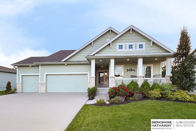 10818 S 109th St, Papillion, NE 68046 - craftsman inspired home featuring an attached garage, driveway, a front yard, covered porch, and stone siding