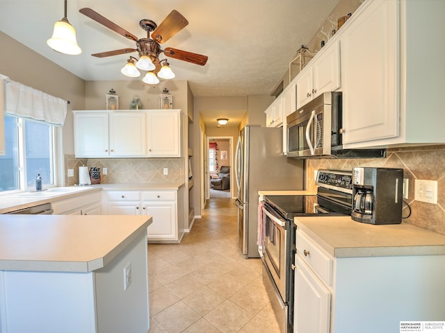 6015 S 163rd Cir, Omaha, NE 68135 - kitchen featuring appliances with stainless steel finishes, ceiling fan, decorative backsplash, and white cabinetry
