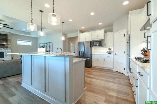 5017 N 209th St, Elkhorn, NE 68022 - kitchen featuring stainless steel appliances, open floor plan, light wood finished floors, ceiling fan, and recessed lighting