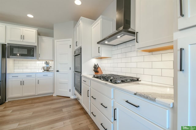 5017 N 209th St, Elkhorn, NE 68022 - kitchen featuring wall chimney range hood, black appliances, white cabinetry, recessed lighting, and light wood finished floors